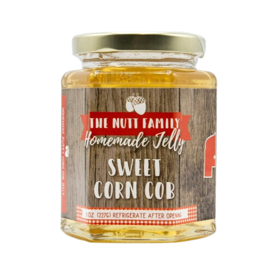 Sweet corn cob jelly in a clear jar, showcasing golden jelly with corn kernels, produced by Nutt Family Jams & Jellies.