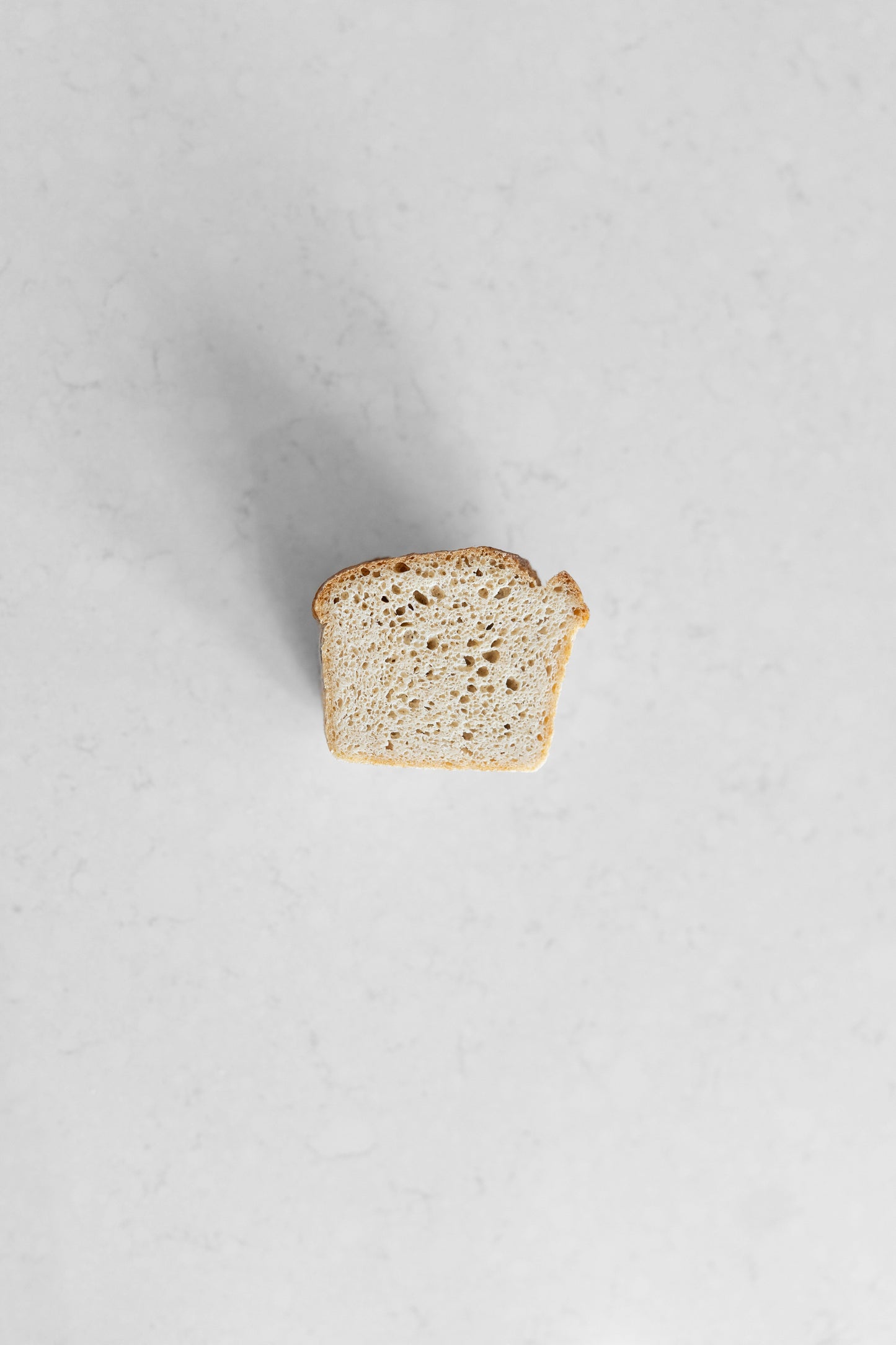 White gluten-free vegan sourdough loaf from Heaven Gluten Free Bakery, fresh and sliced with a rustic crust and soft interior.