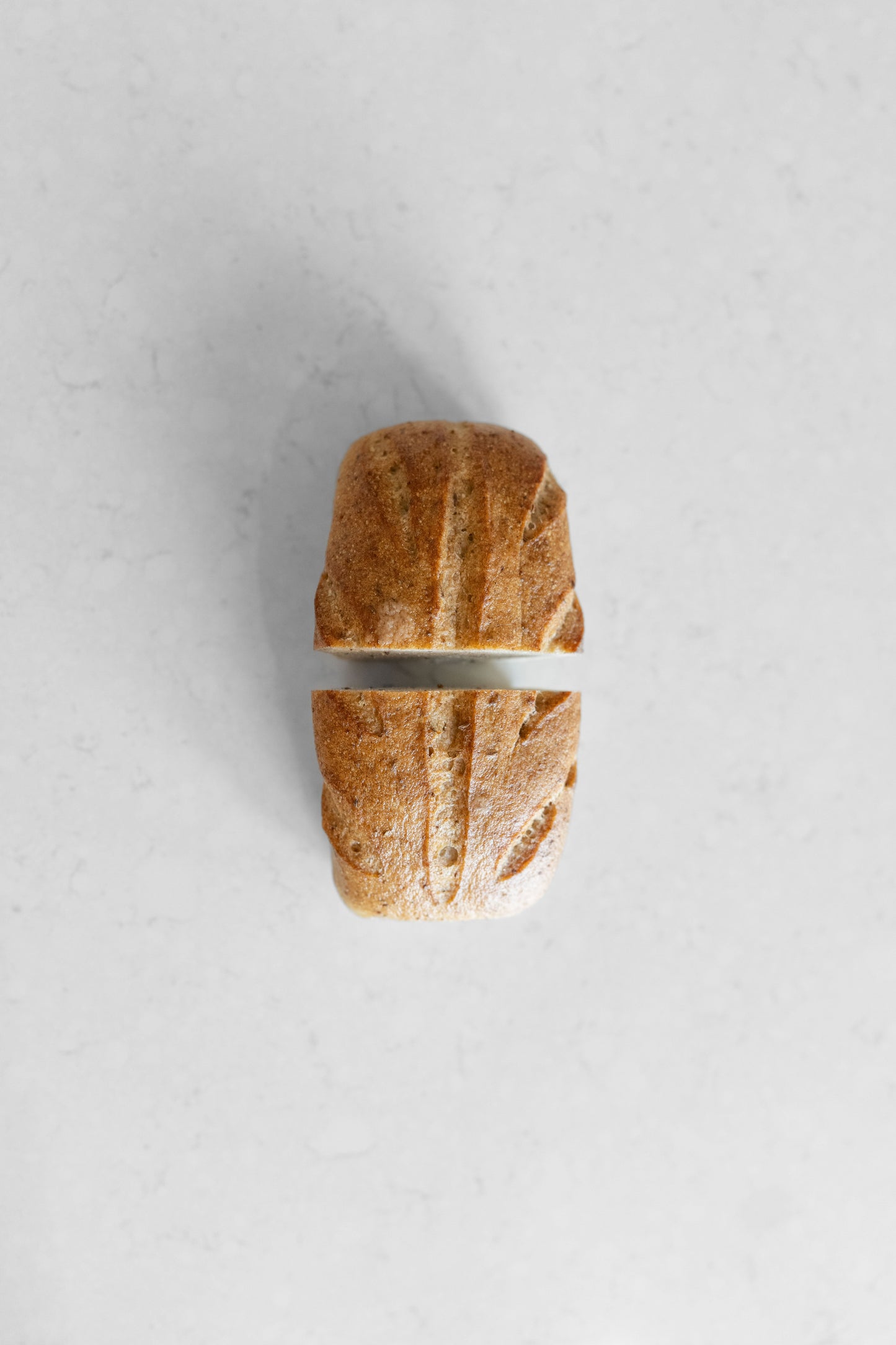 Sourdough loaf from Heaven Gluten Free Bakery, gluten-free and vegan Caraway Sourdough bread on a wooden board.