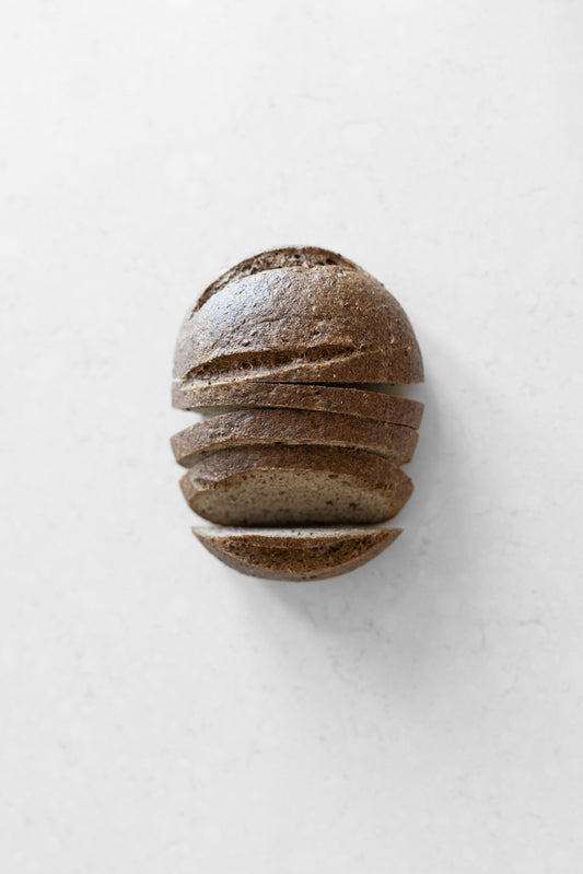 Vegan gluten-free sourdough boule with flaxseed and allspice from Heaven Gluten Free Bakery, showing a round, rustic loaf.