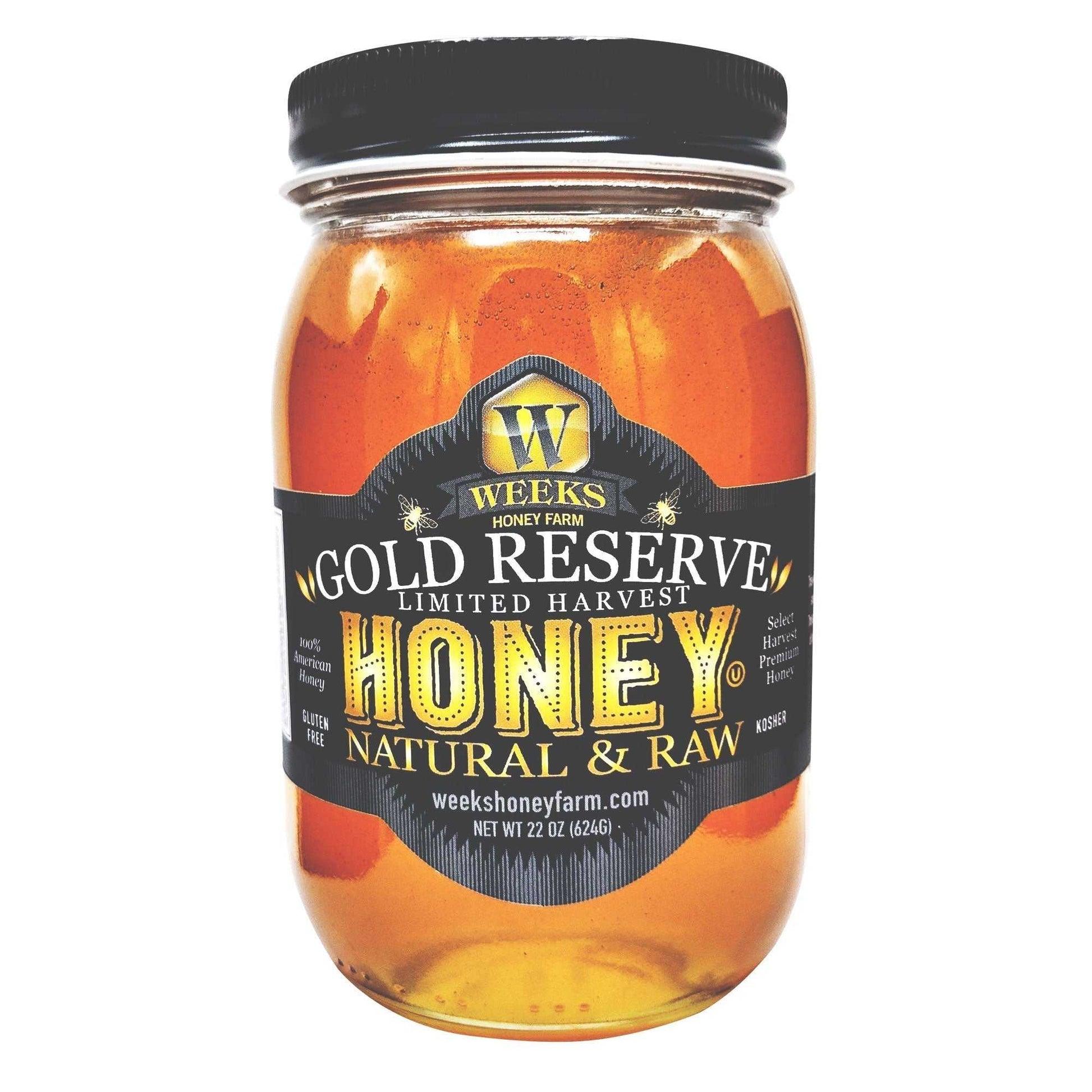 A clear glass jar of Weeks Raw Gold Reserve Honey, Special Edition—an unfiltered natural honey from Georgia by Weeks Honey Farm. The black label with gold accents highlights this 22 oz (624g) premium raw honey.