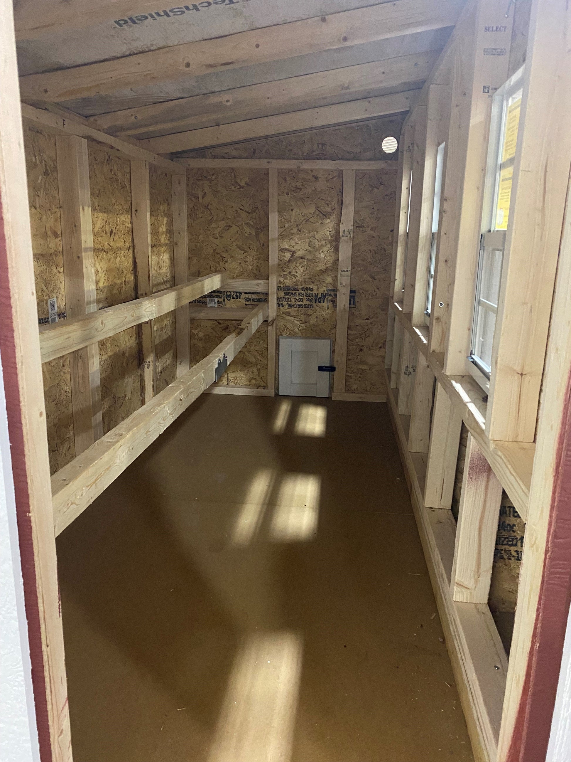 Large OverEZ Chicken Coop interior with space for up to 20 chickens, showing nesting boxes and roosting areas inside.