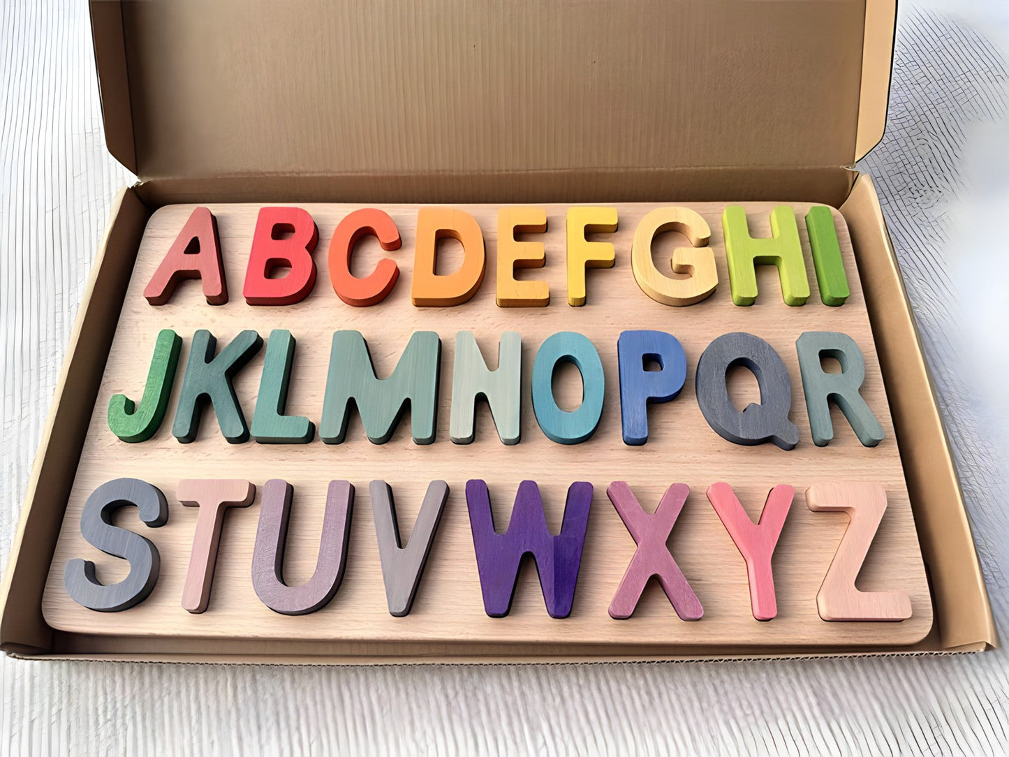 Colorful Montessori wooden puzzles by Petite Pioneers, featuring alphabet pieces for early learning and development.
