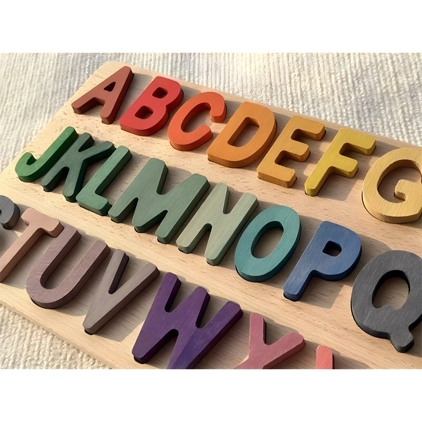Colorful Montessori wooden alphabet puzzles by Petite Pioneers featuring letter pieces and animal illustrations for early learning.