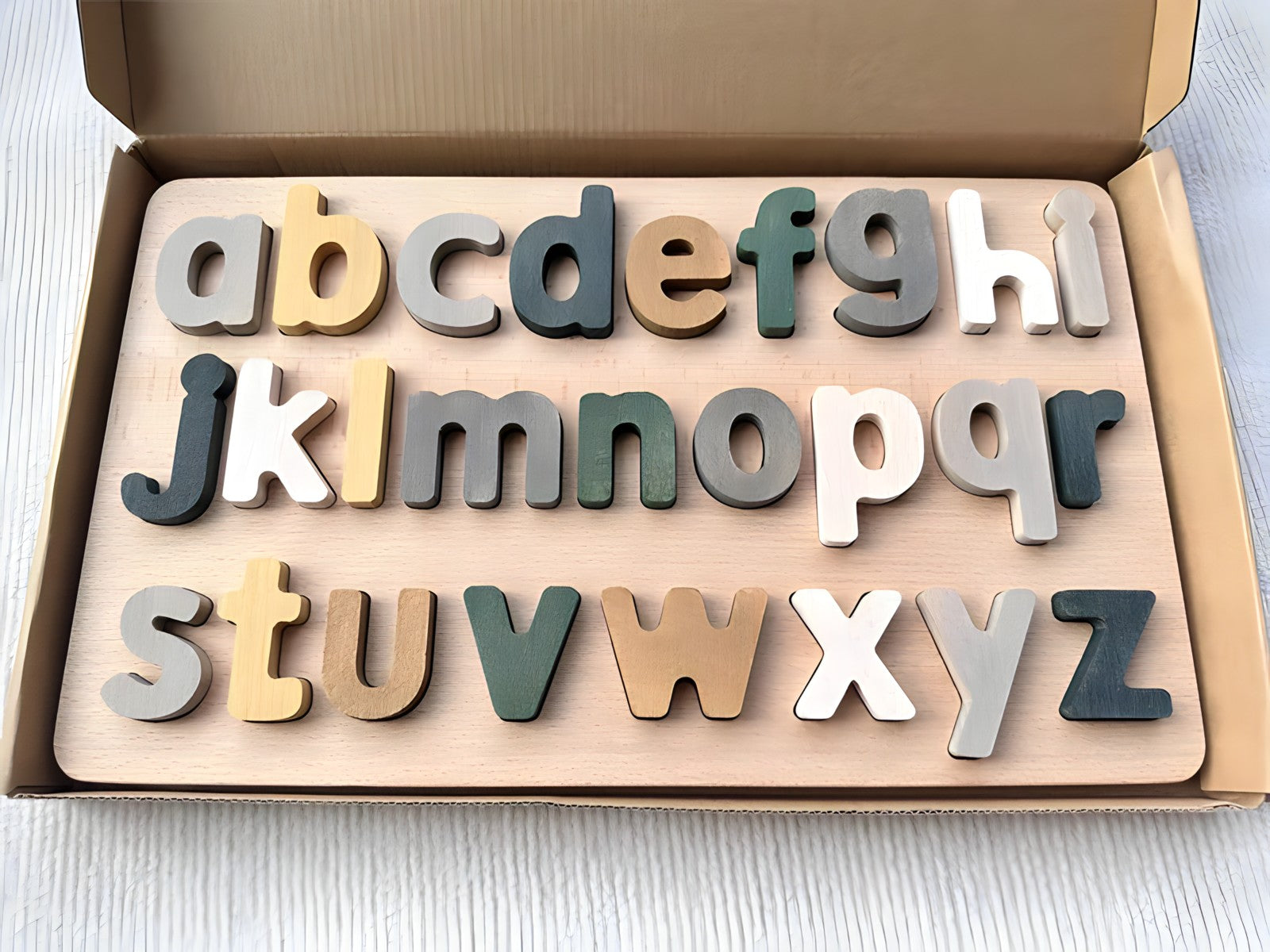 Colorful Montessori wooden puzzles by Petite Pioneers featuring alphabet and number pieces for early childhood learning.