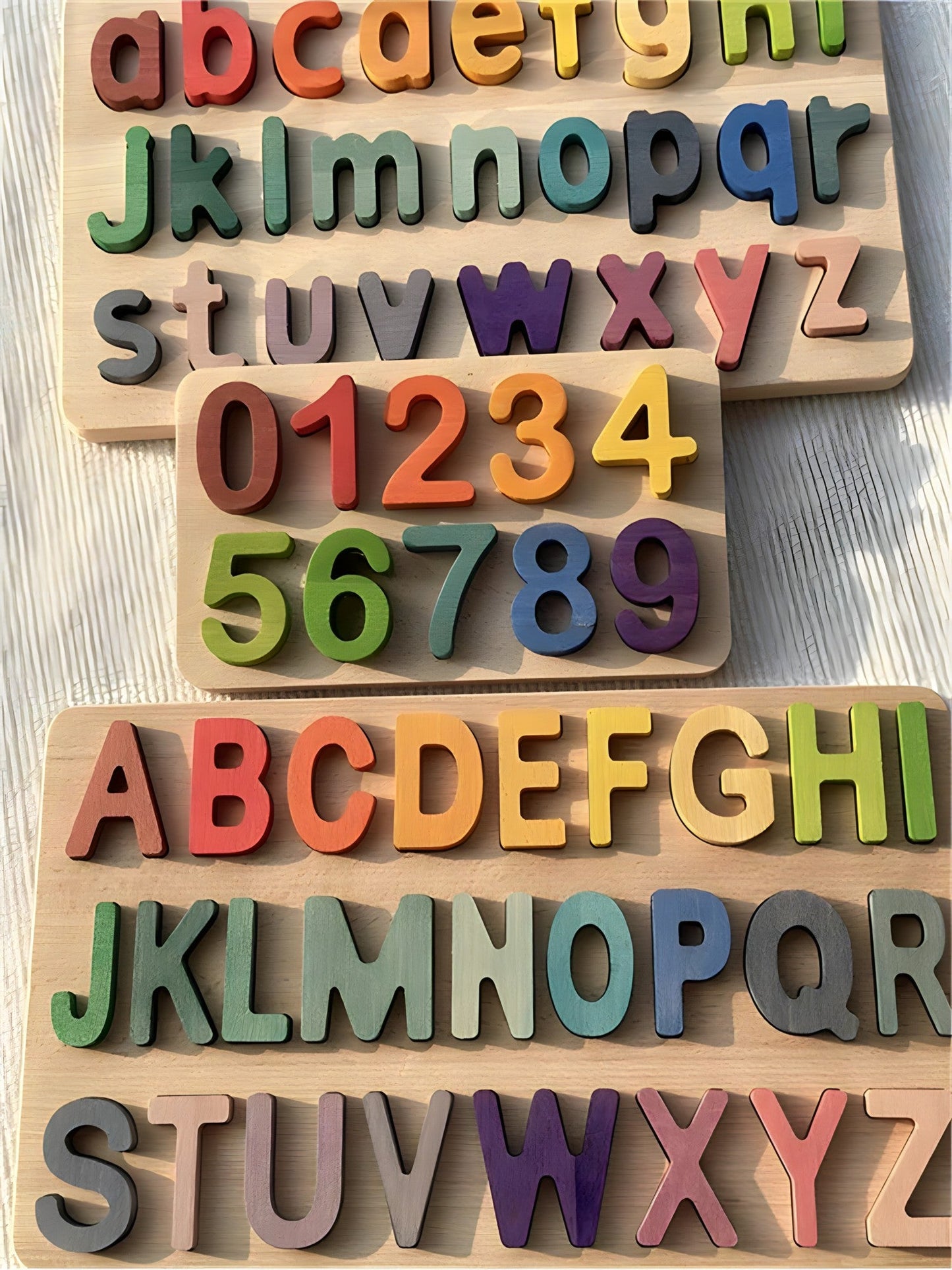 Colorful Montessori wooden ABC puzzles by Petite Pioneers featuring alphabet letter pieces for early learning and fine motor skill development.
