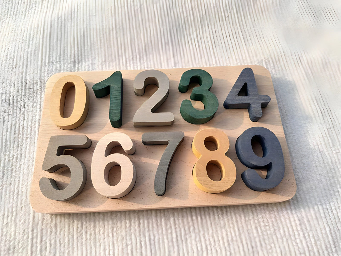 Colorful Montessori wooden puzzles by Petite Pioneers featuring alphabet and number pieces for early childhood learning.