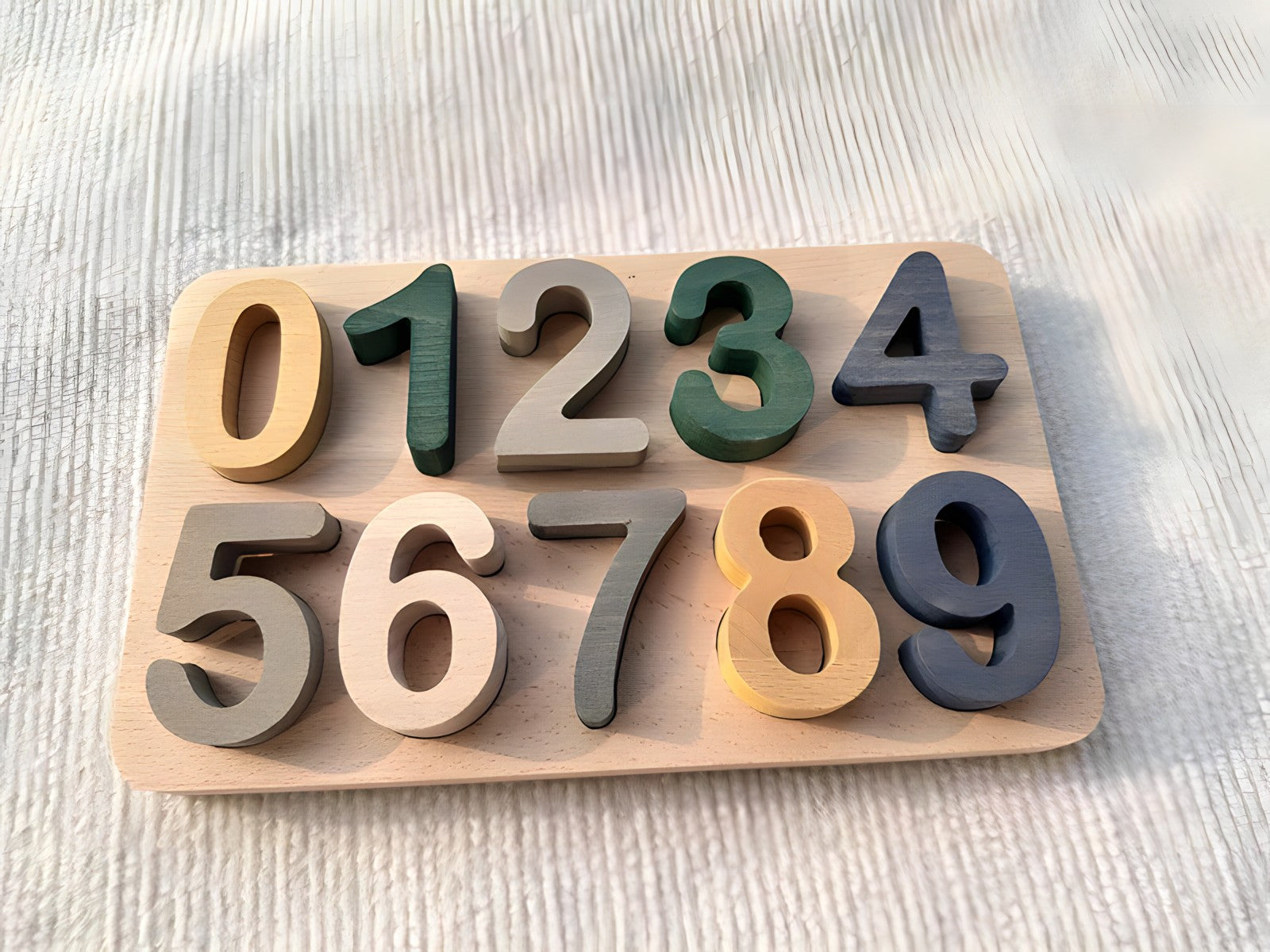 Colorful Montessori wooden puzzles by Petite Pioneers featuring alphabet and number pieces for early childhood learning.
