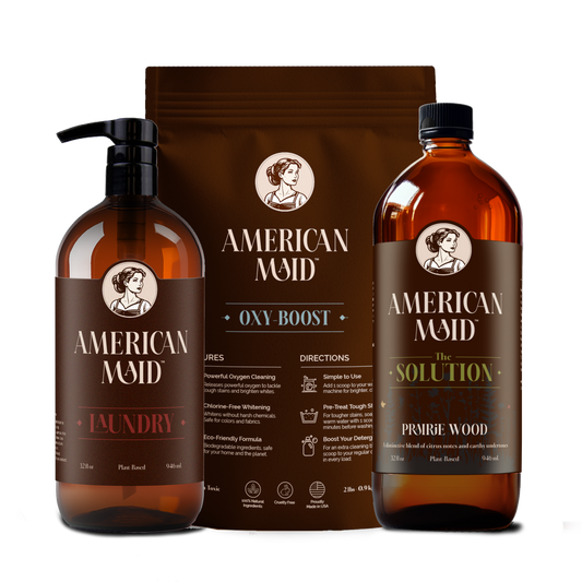 American Maid Laundry Essentials Kit with Prairie Wood scent, includes detergent, fabric softener, and stain remover bottles.