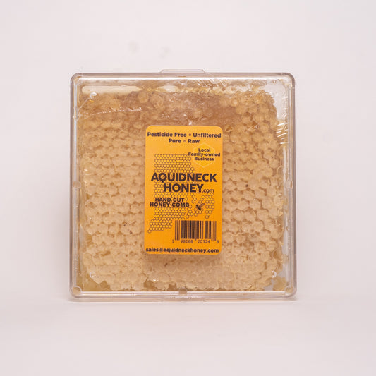 Small New England hand-cut honey comb from Aquidneck Honey, showcasing golden honey and natural beeswax in a rustic frame.
