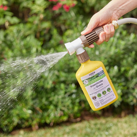 Organic insecticide for grass, trees, and shrubs by Arber, showing a garden with healthy plants and a spray bottle in use.