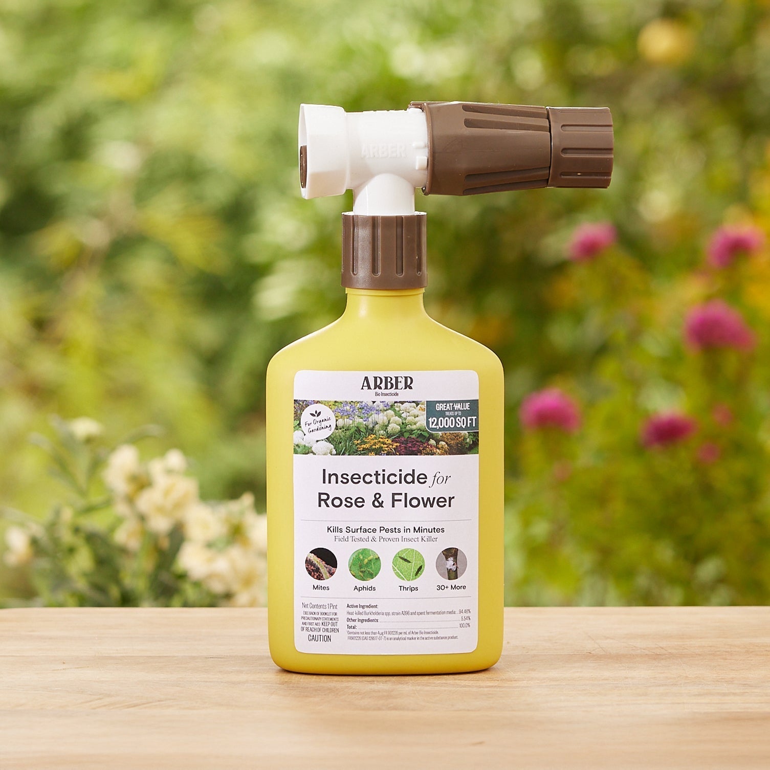 Organic insecticide for roses and flowers by Arber, featuring a spray bottle and blooming garden roses.