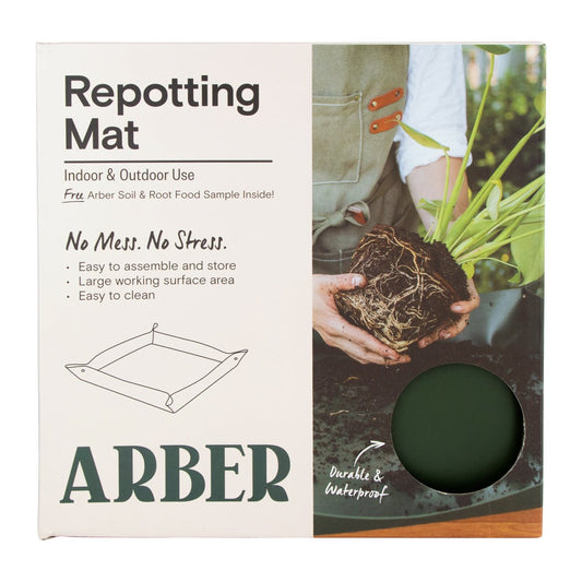 Arber repotting mat in use, protecting surfaces during plant repotting with a durable, flexible gardening accessory.