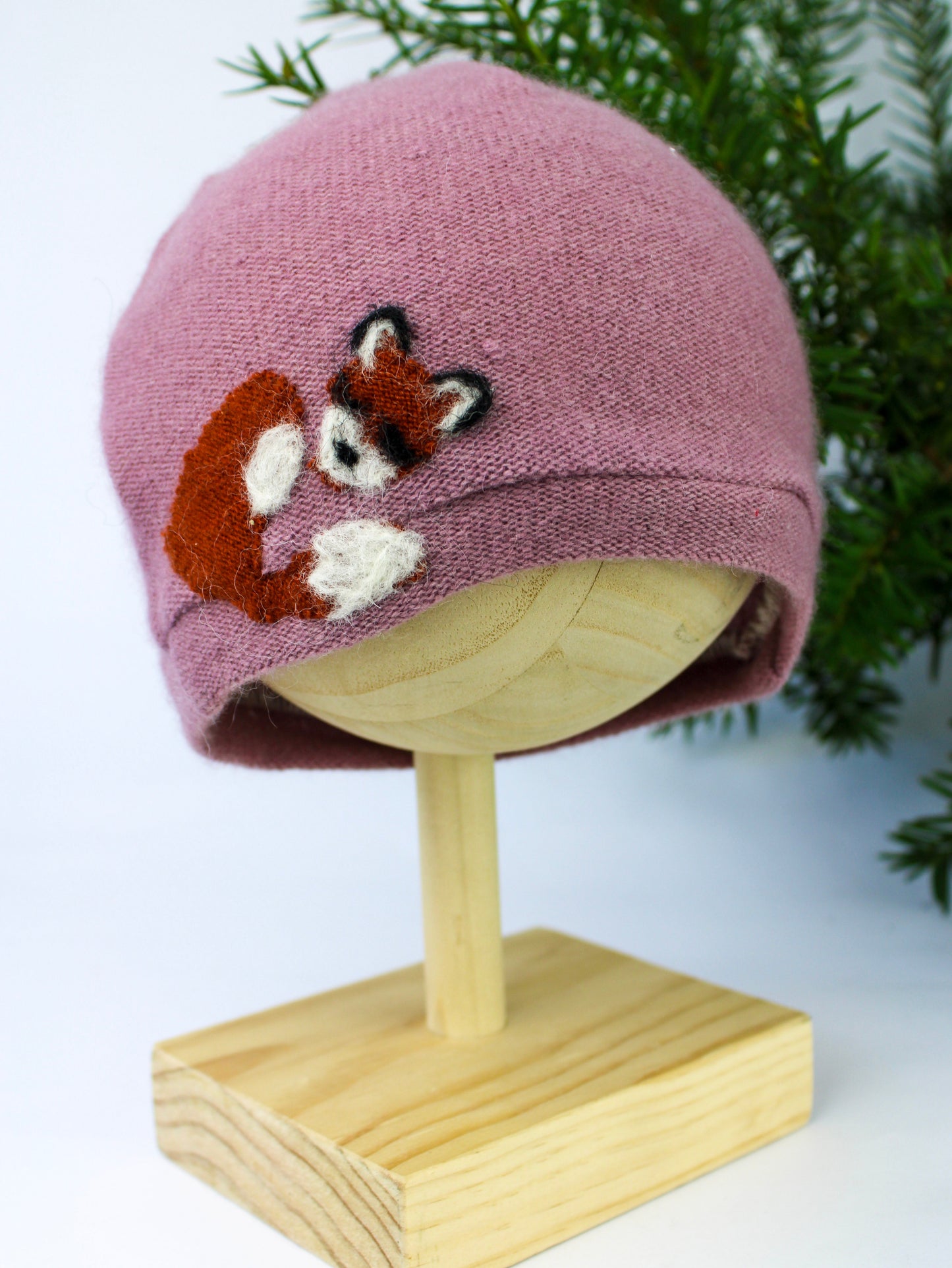 The Sleeping Fox Cashmere Hat - Child by Ash & Rose is a soft mauve handmade kids hat, featuring a felted curled-up fox and crafted from upcycled materials.
