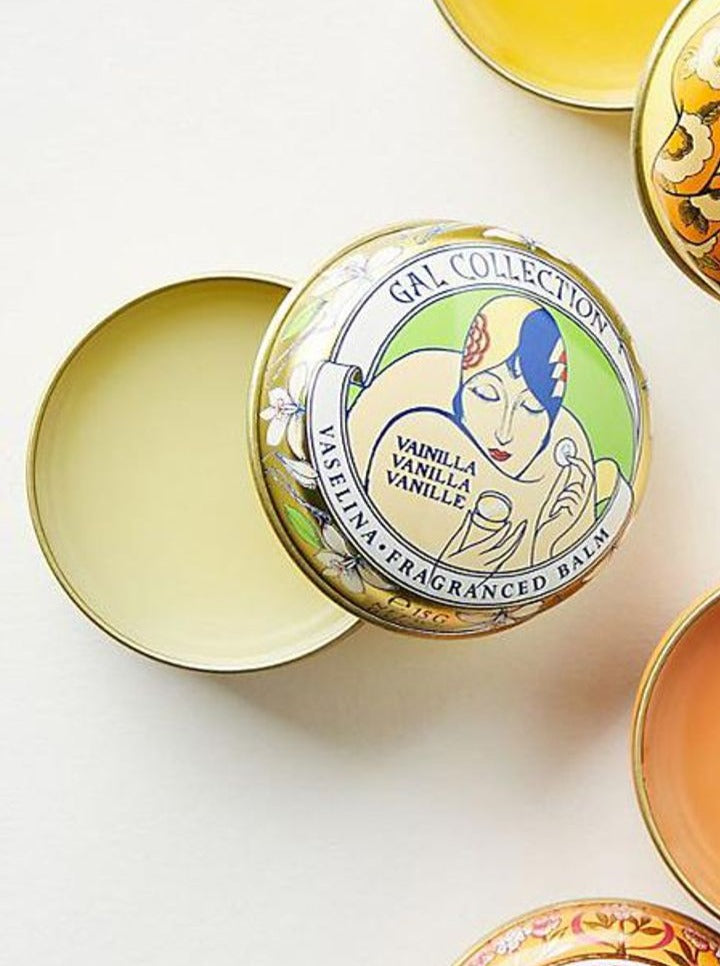 Ash & Rose Perfumeria Gal scented lip balm in orange flavor, featuring a sleek container and natural ingredients.