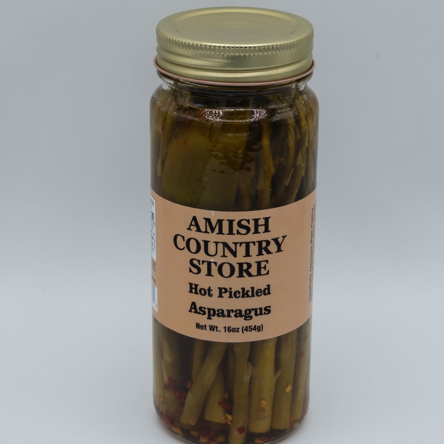 Jar of Amish Country Store hot pickled asparagus in a 16oz glass jar with visible asparagus spears inside.