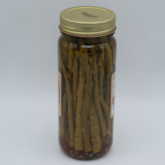 Jar of Amish Country Store Zesty Pickled Asparagus in a 16oz jar, showcasing vibrant green pickled asparagus spears.