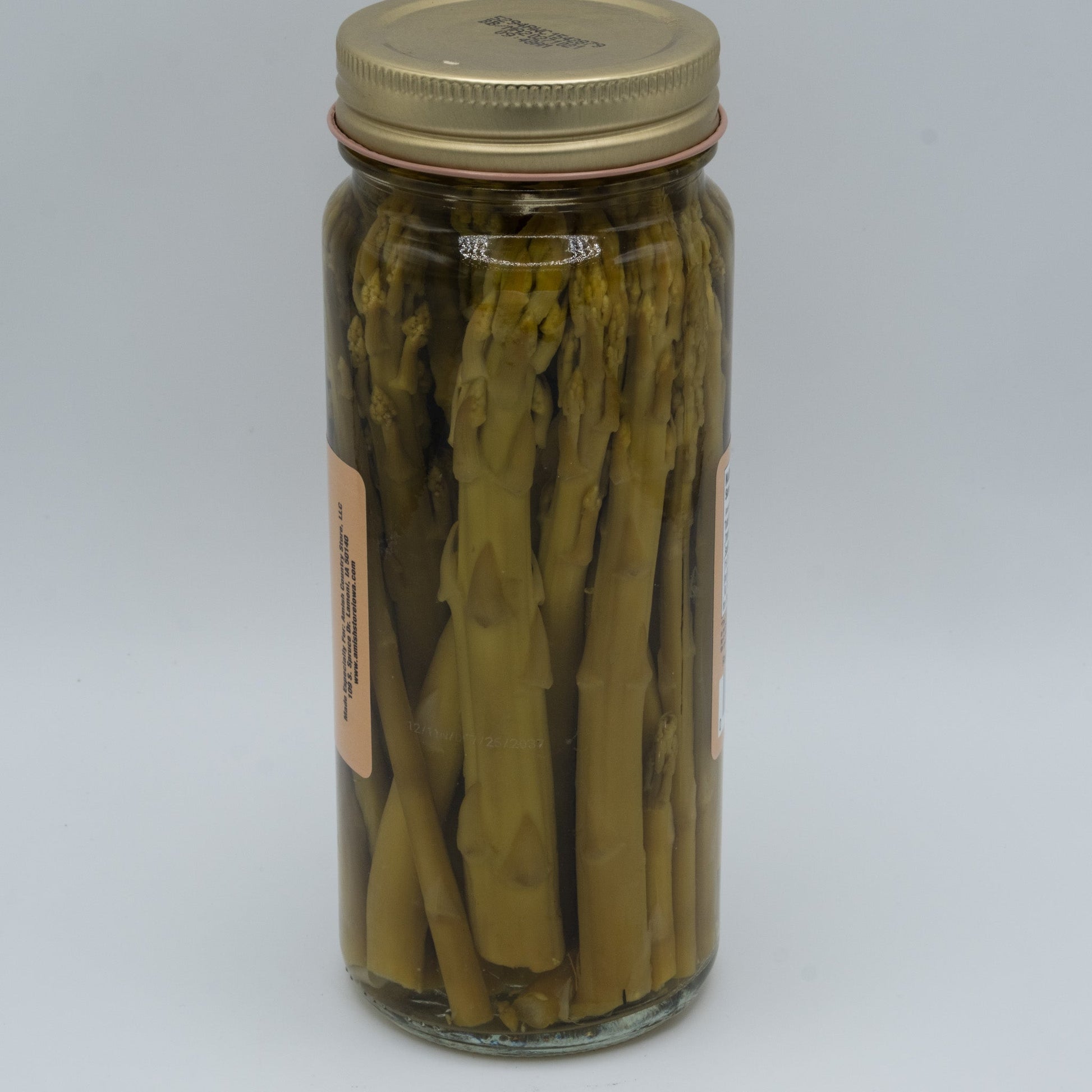 Jar of Amish Country Store pickled asparagus in a 16oz jar, showcasing vibrant green asparagus spears immersed in pickling liquid.