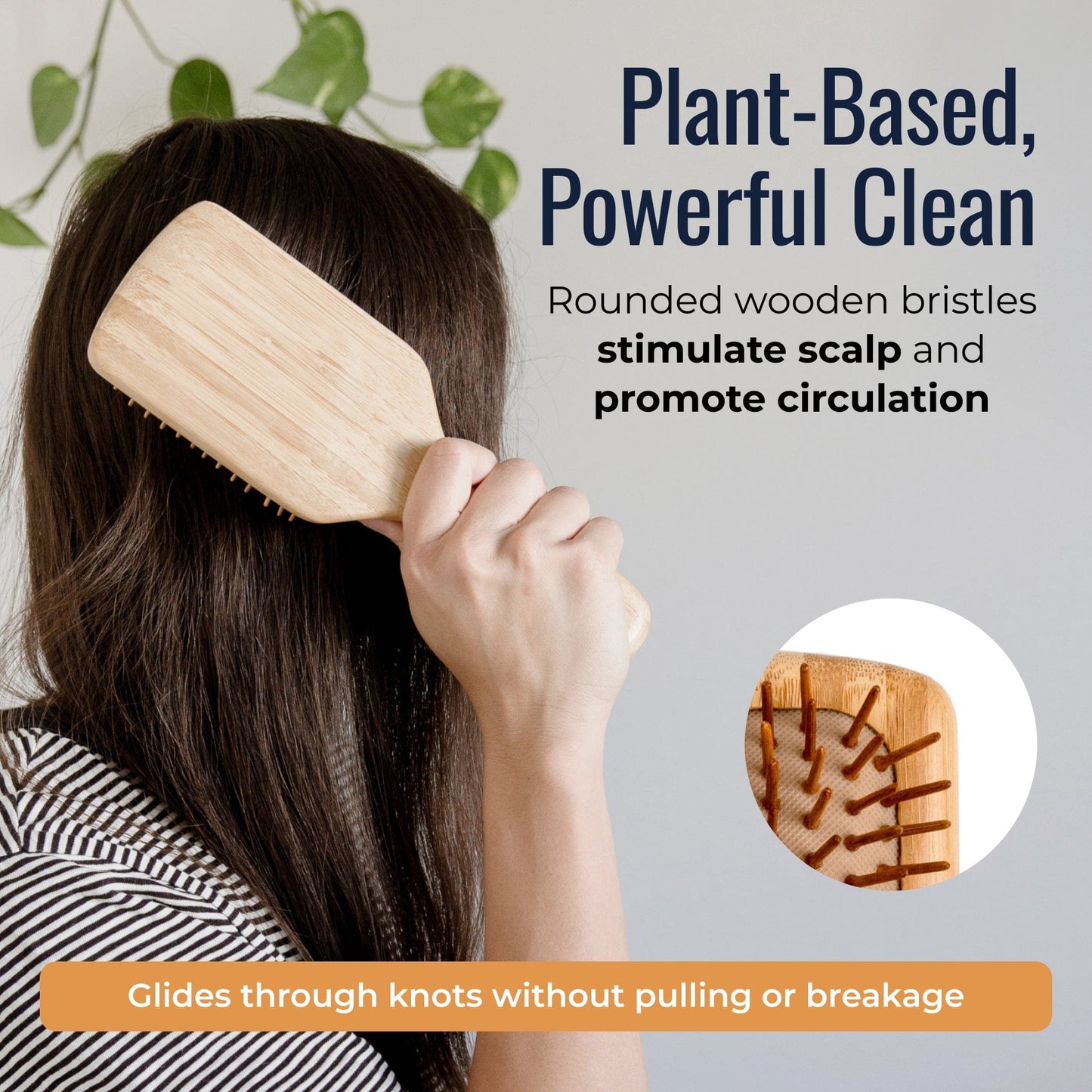 Bamboo hair brush from ZeroWasteStore.com with wooden bristles and ergonomic handle for gentle styling and detangling.