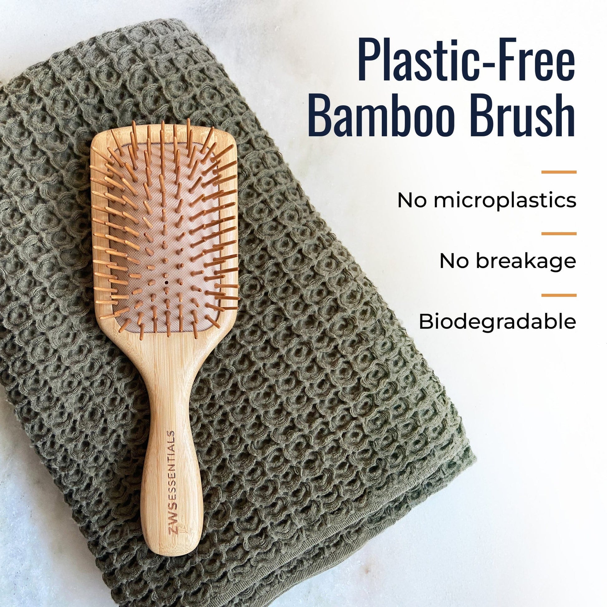 Bamboo hair brush from ZeroWasteStore.com with wooden bristles and ergonomic handle, designed for gentle hair detangling.