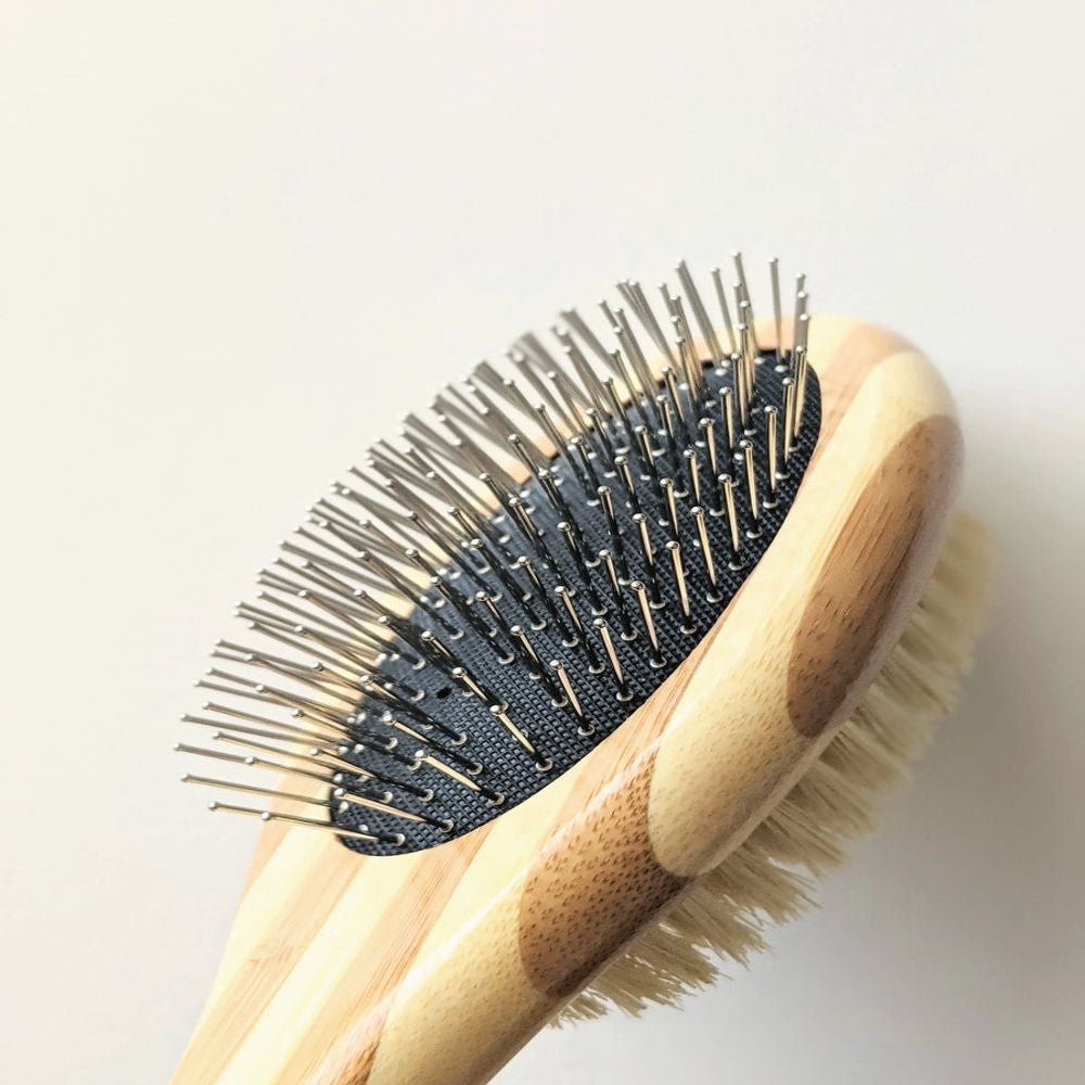 Tilley + Me two-sided dog grooming brush with bamboo handle, featuring bristle and wire sides for shedding and detangling.