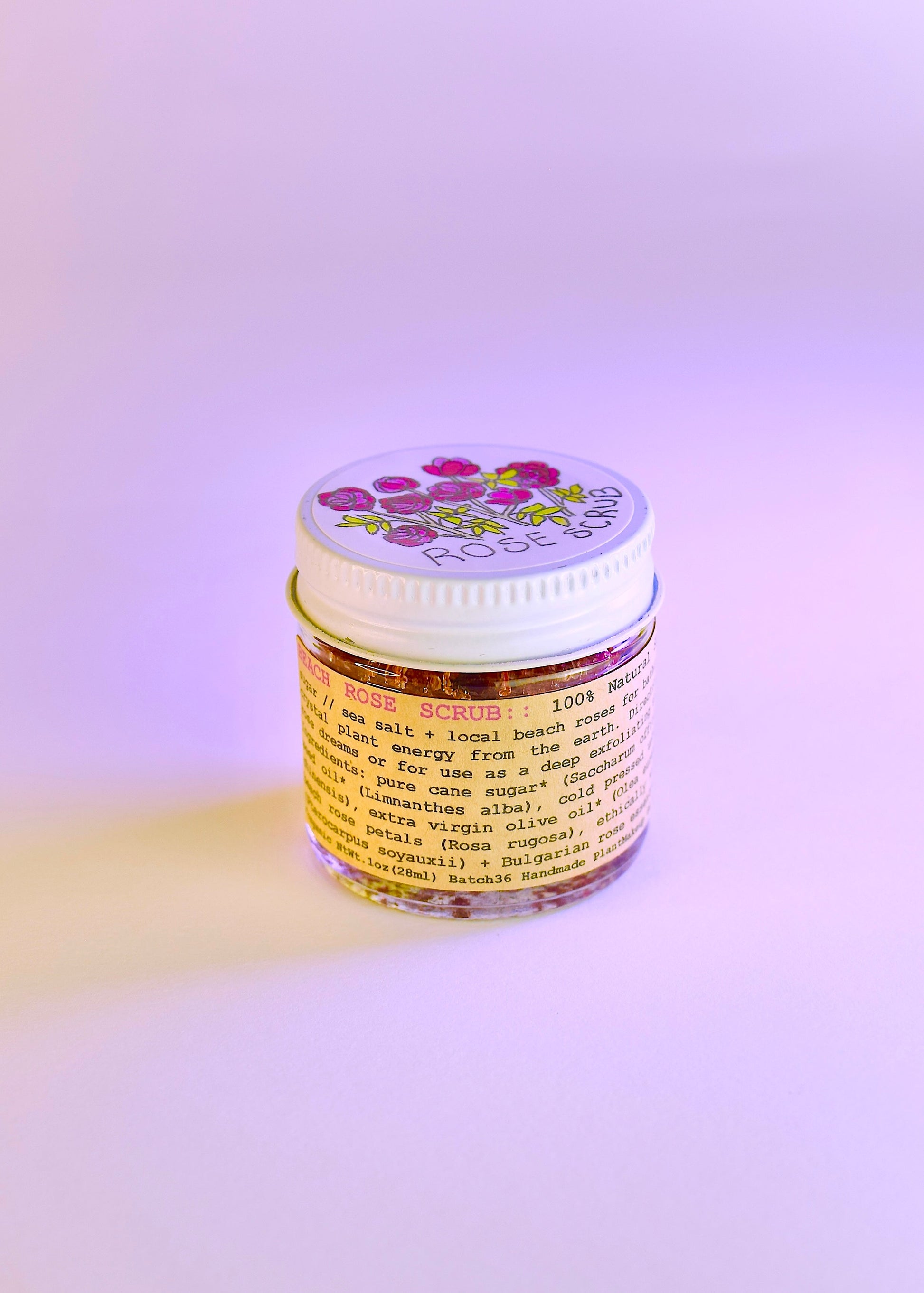 Plant Makeup Beach Rose Scrub in a jar with rose petals, showcasing natural exfoliating ingredients and floral design.