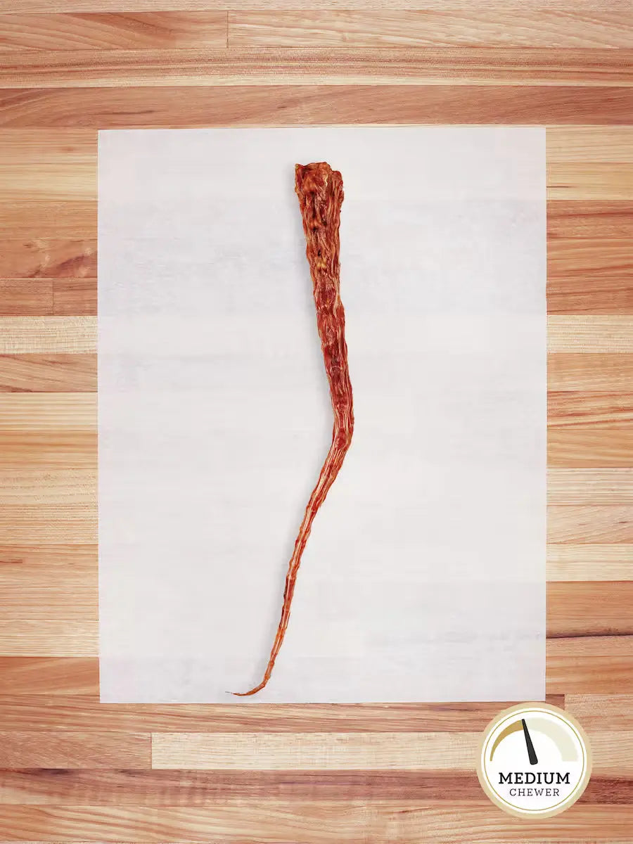 Farm Hounds beef tail chew for dogs, showing a natural beef tail chew with textured surface and meaty appearance.