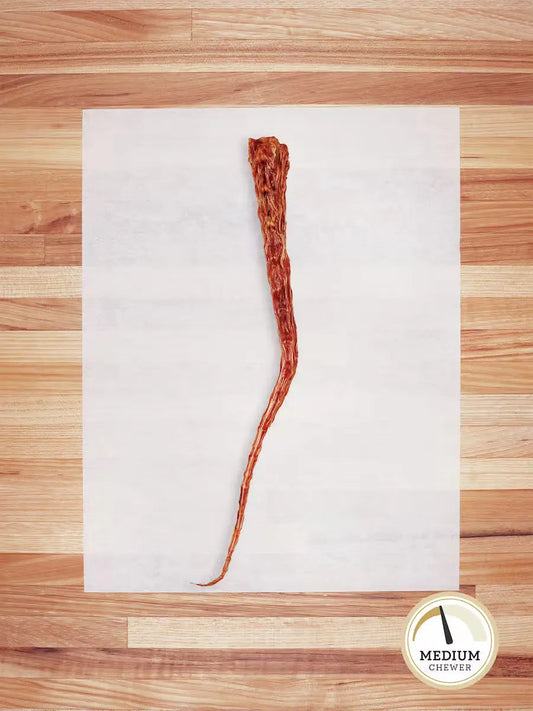 Farm Hounds beef tail chew for dogs, showing a natural beef tail chew with textured surface and meaty appearance.