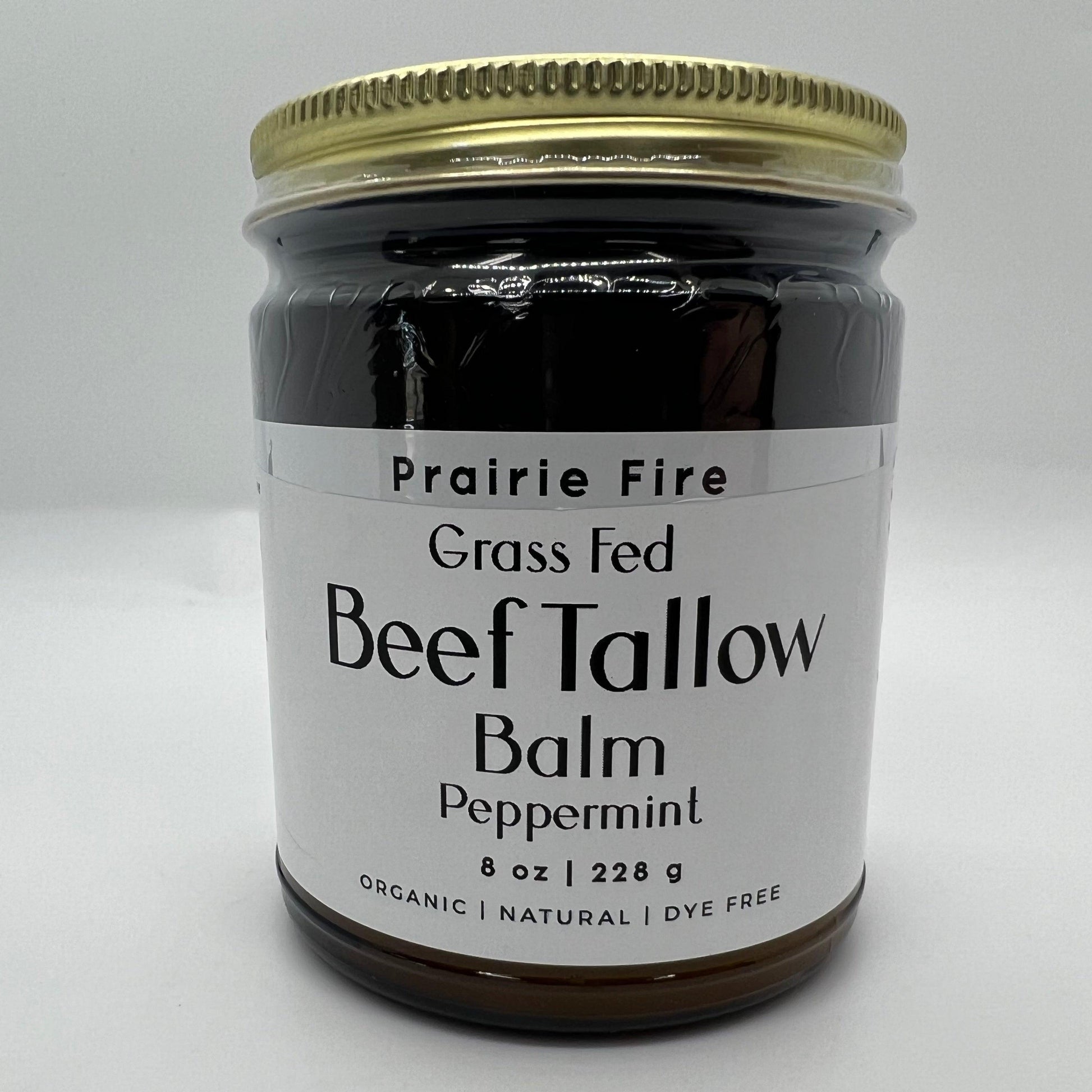 A jar of Prairie Fire Tallow, Candles, and Lavender Beef Tallow Balm – 8 oz, organic, grass fed & finished – with a gold lid. Made in USA, dye free moisturizer for skin care shown on a plain white background.
