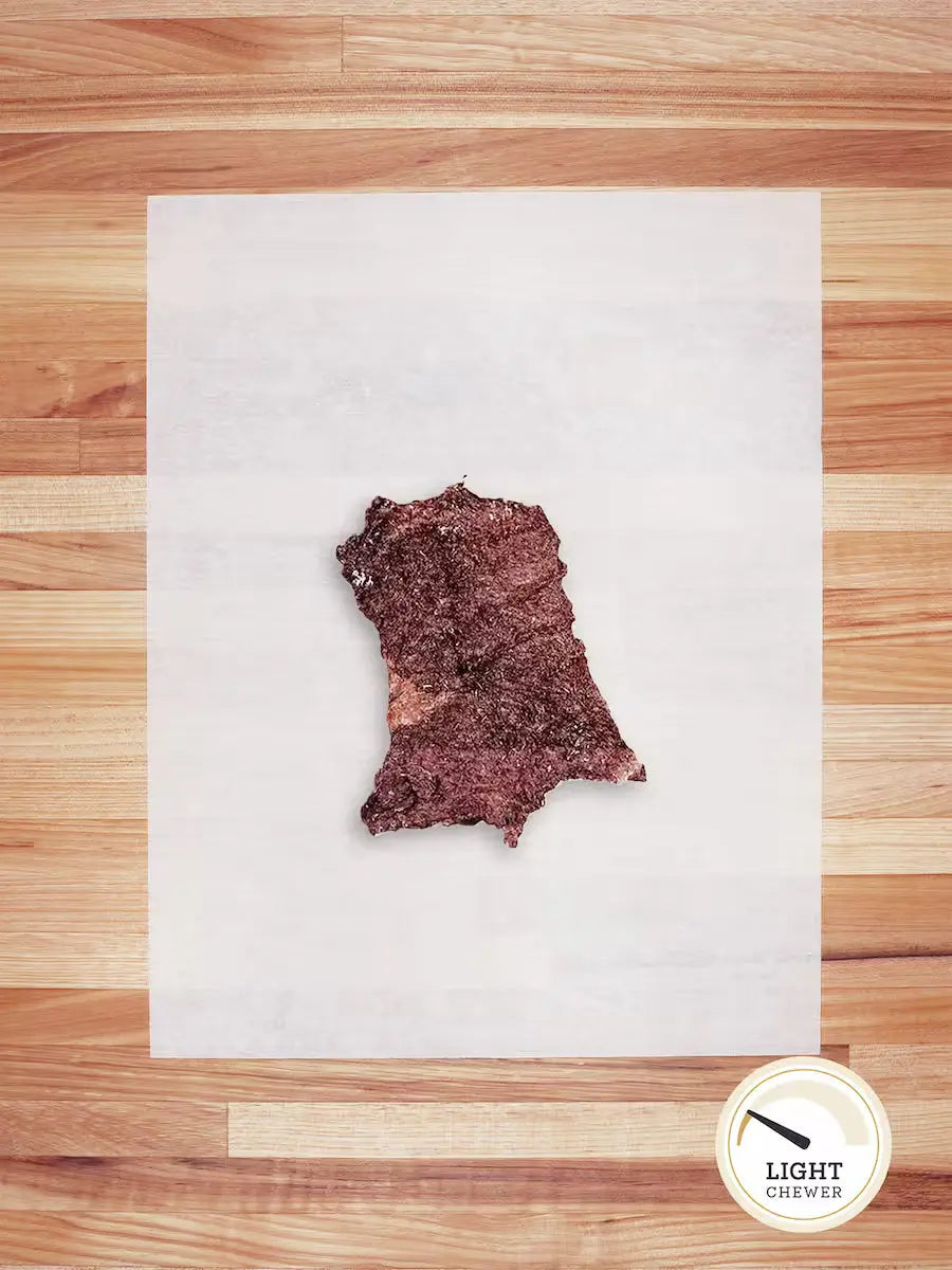 Green beef tripe chew from Farm Hounds, showing a close-up of fresh, natural beef tripe scraps in a natural setting.