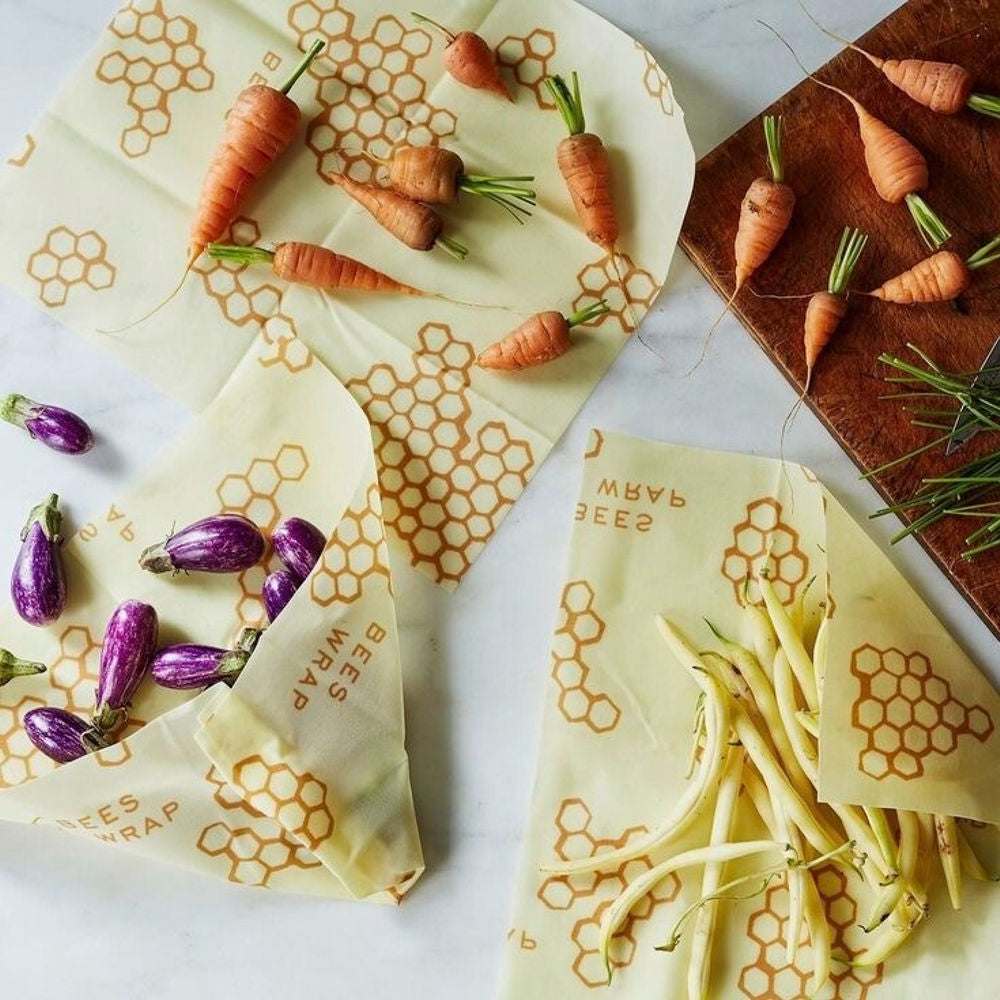 Set of reusable Tilley + Me beeswax food wraps in various sizes, showcasing eco-friendly organic fabric and beeswax coating.
