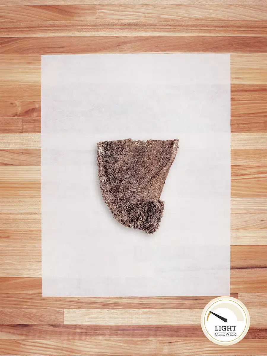 Dehydrated green bison tripe chew for dogs from Farm Hounds, showing textured bison tripe scraps in natural lighting