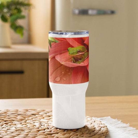The Blessings Grow Meadows Frog and Dahlia Original Photography mug features a white stainless steel design with a handle, showing a green frog on a pink dahlia, and includes a spill-proof lid—perfect as your go-to travel mug.