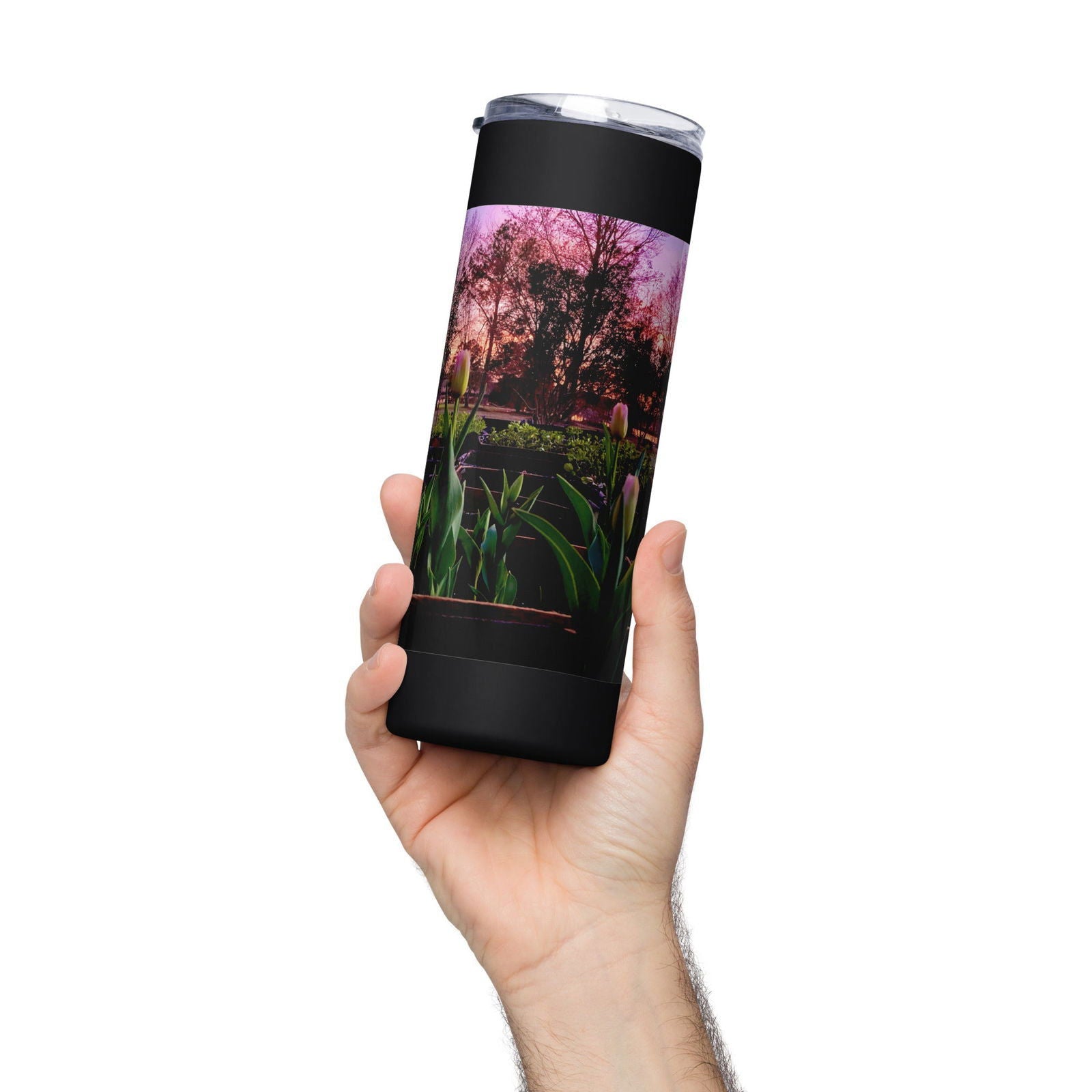 Black tumbler featuring a sunset garden scene with vibrant pink and purple hues, lush green plants, and budding tulips near silhouetted trees