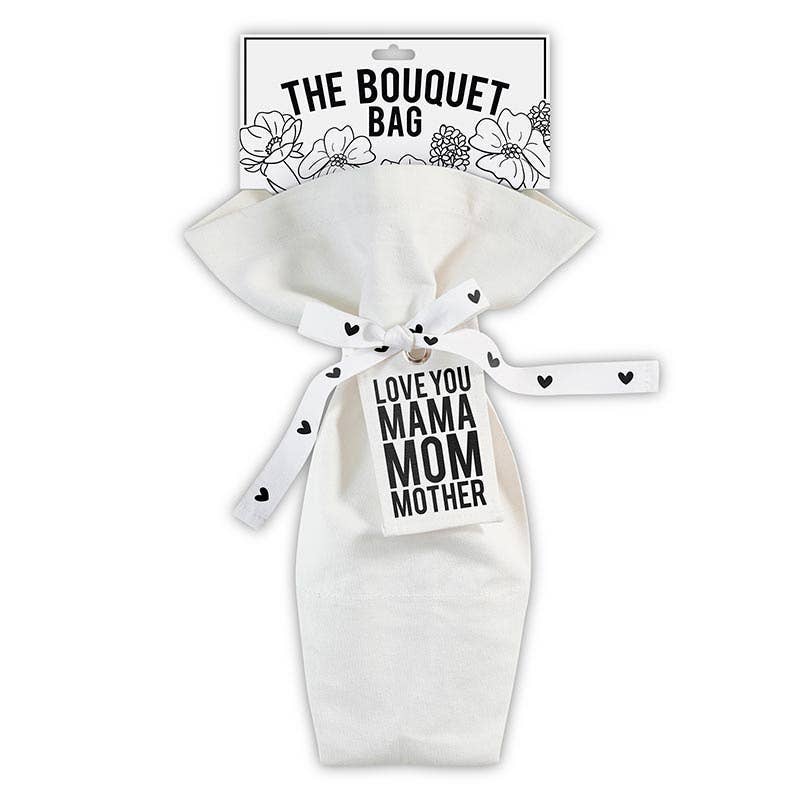 The Bouquet Bag - Mama by Blessings Grow Meadows Merch & More is a white reusable canvas flower bag with a black-and-white floral design, ribbon tie, and tag reading LOVE YOU MAMA MOM MOTHER—an ideal gift for mama.