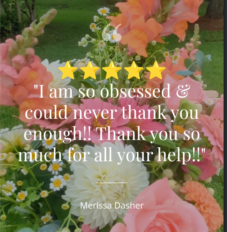 Photograph of a vibrant floral arrangement featuring coral snapdragons, peach dahlias, and white daisies.
