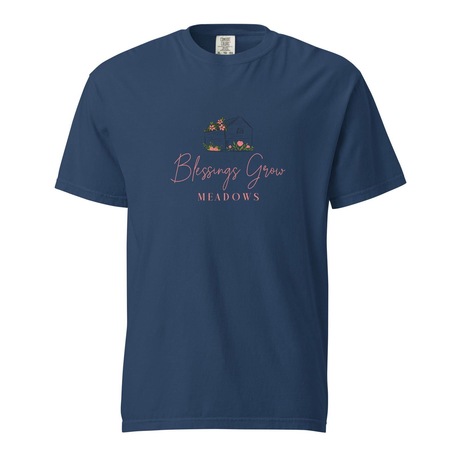 Comfort Colors t-shirt featuring Blessings Grow Meadows logo design showing a dark house with pink flowers and green grass

