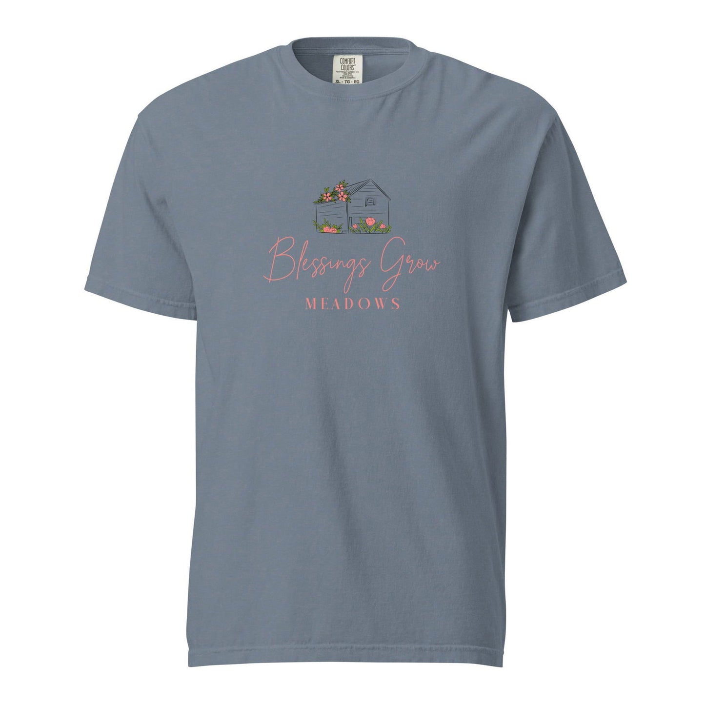 Comfort Colors t-shirt design featuring a gray house with pink flowers and tulips in a meadow the text Blessings Grow Meadows is displayed below