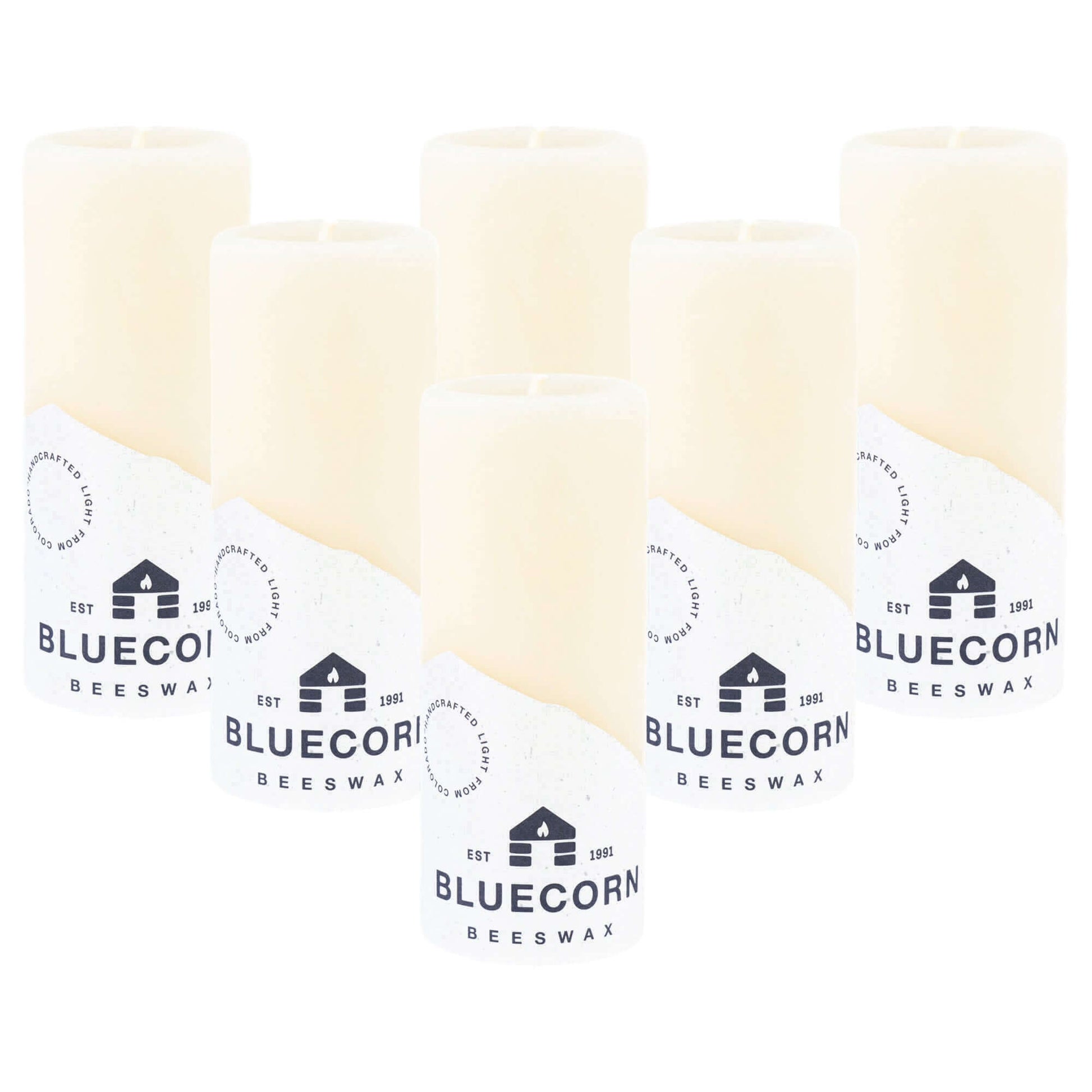 Two ivory Bluecorn Candles pure beeswax pillar candles with a smooth finish and natural appearance.