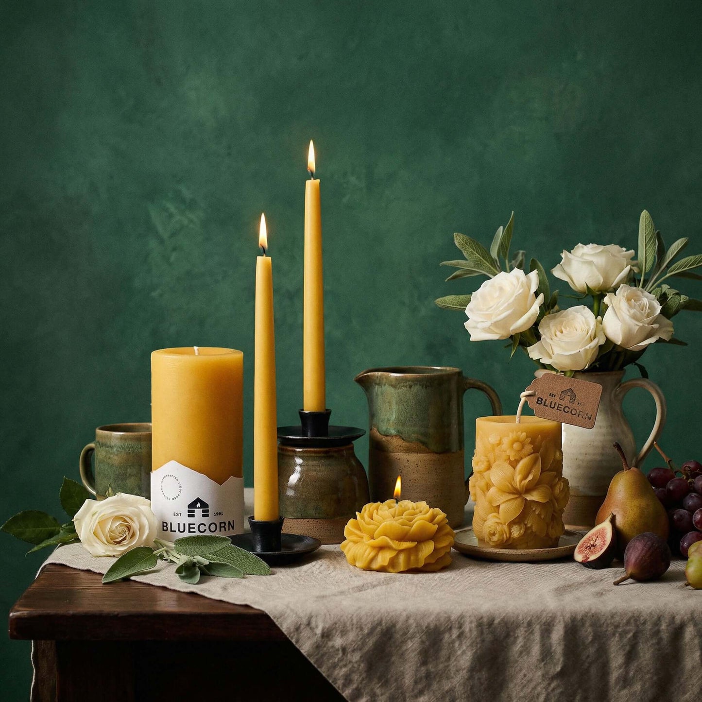 Bluecorn Candles hand-dipped beeswax taper candles in a spring assortment, lit and arranged in a bulk 4-pair bundle.
