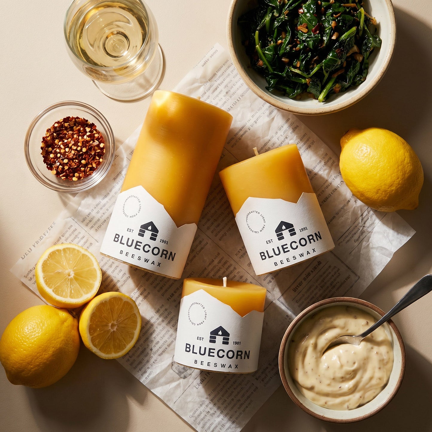 Set of Bluecorn Candles pure beeswax pillar candles on a dinner table, showcasing natural honey-colored beeswax and smooth cylindrical shapes.