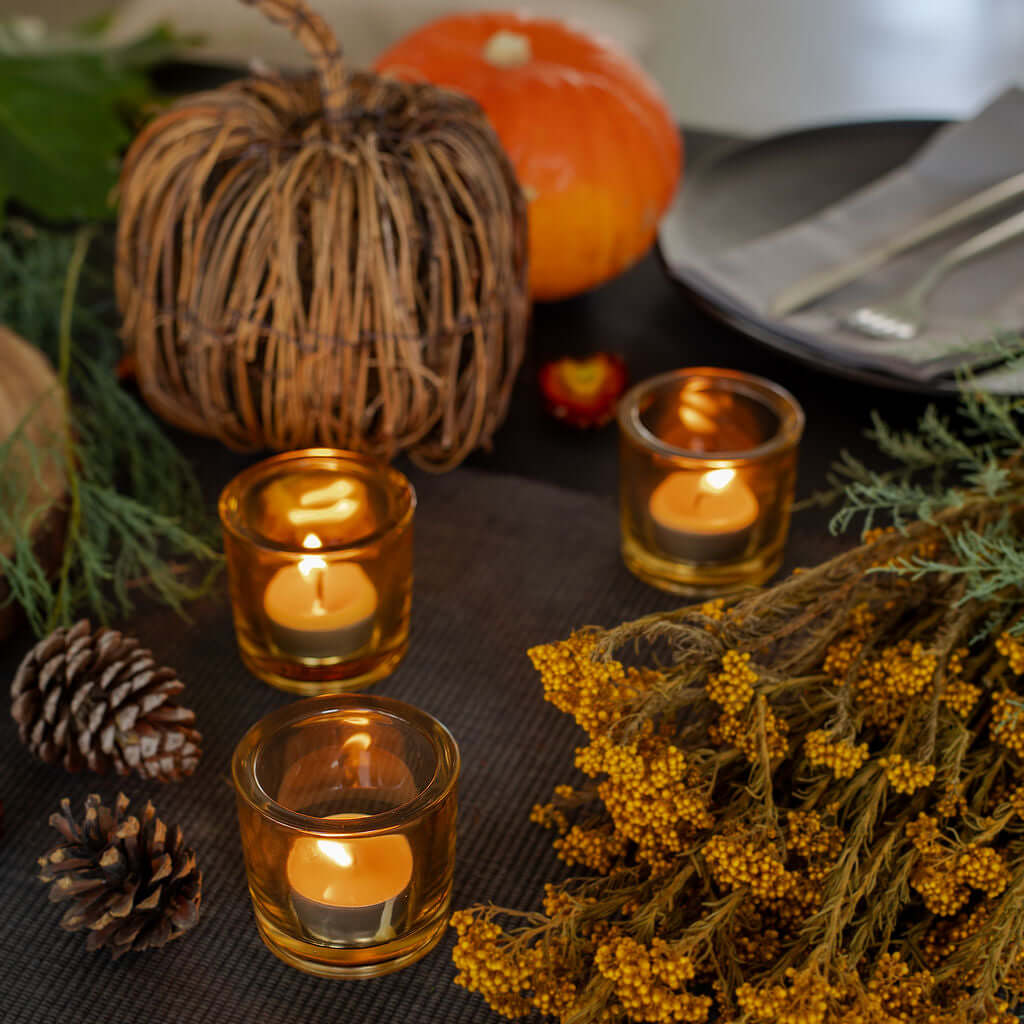 Pure beeswax tea light candles by Bluecorn Candles on a fall table, showcasing warm, natural beeswax glow and sleek candle design.