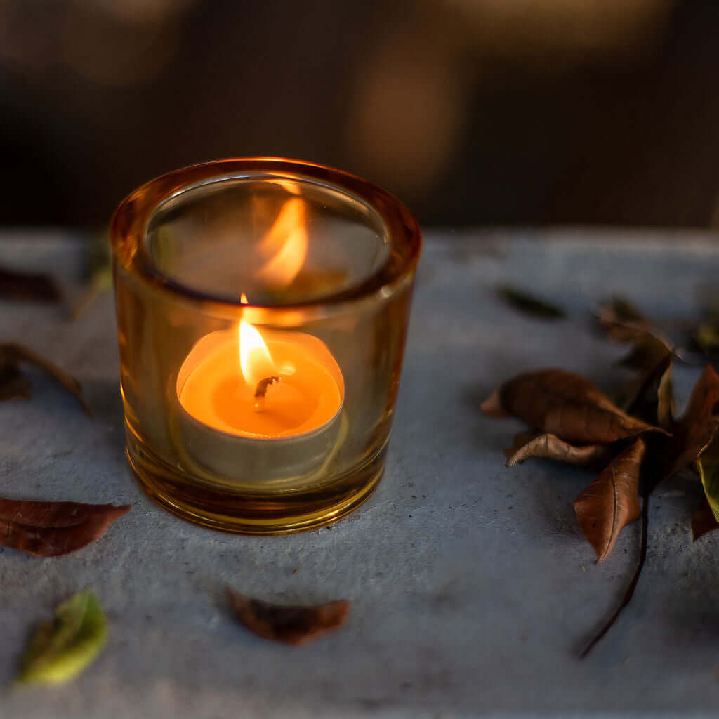 Bluecorn Candles pure beeswax tea light candle in a glass holder, showcasing a warm, natural glow and clean-burning design.