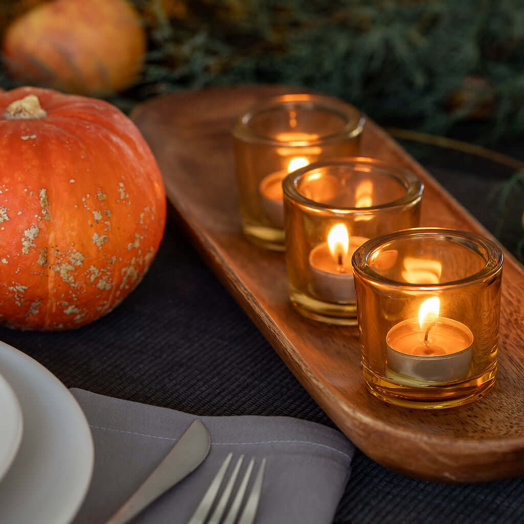Bluecorn Candles pure beeswax tea light candles in glass jars, showcasing warm glow and natural beeswax texture.