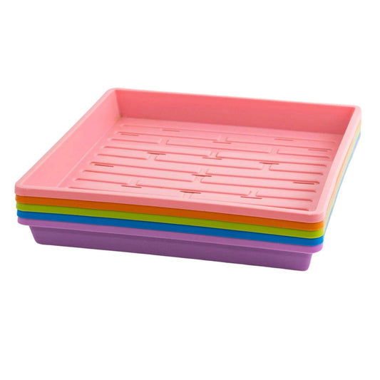 Plastic stacking trays in pink orange green blue and purple showing ribbed texture and a square shape
