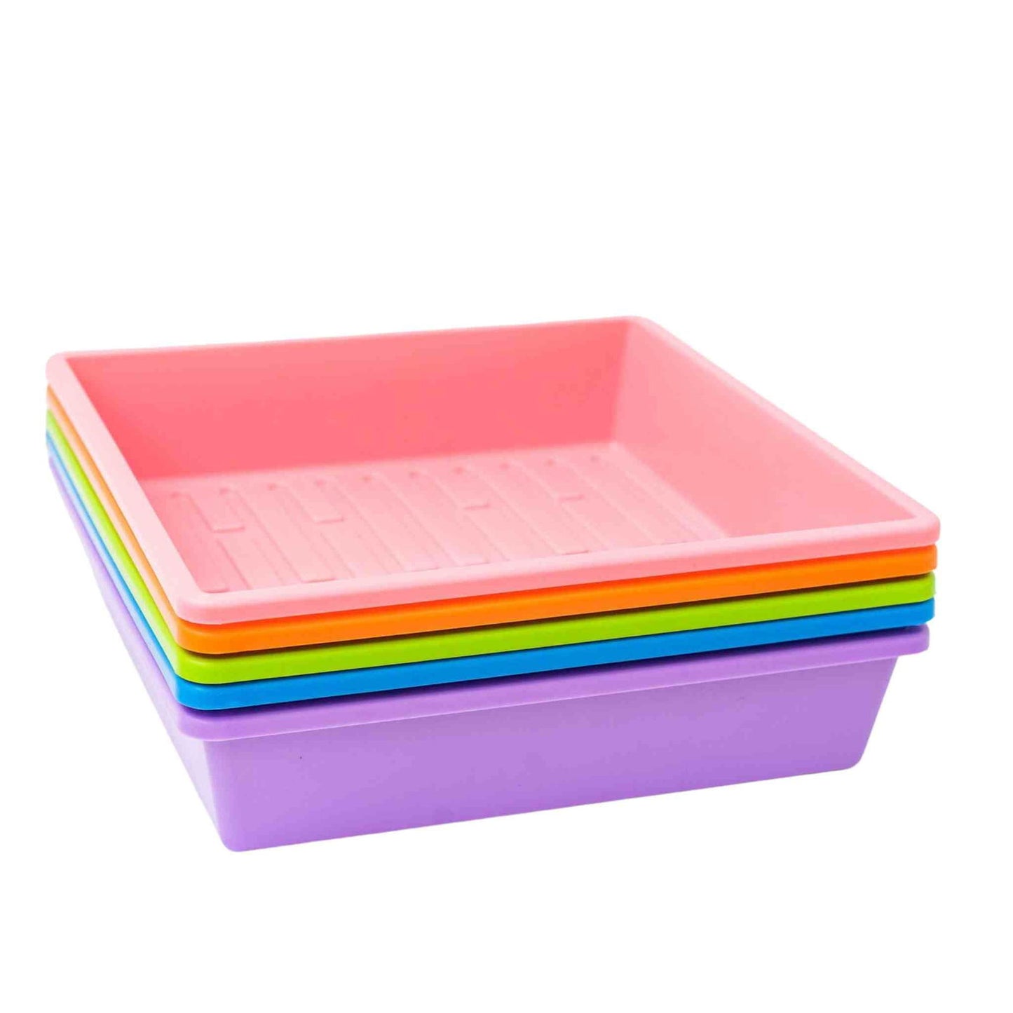 Plastic trays in pink orange green blue and purple tones stacked on a white background showing ribbed texture and vibrant colors
