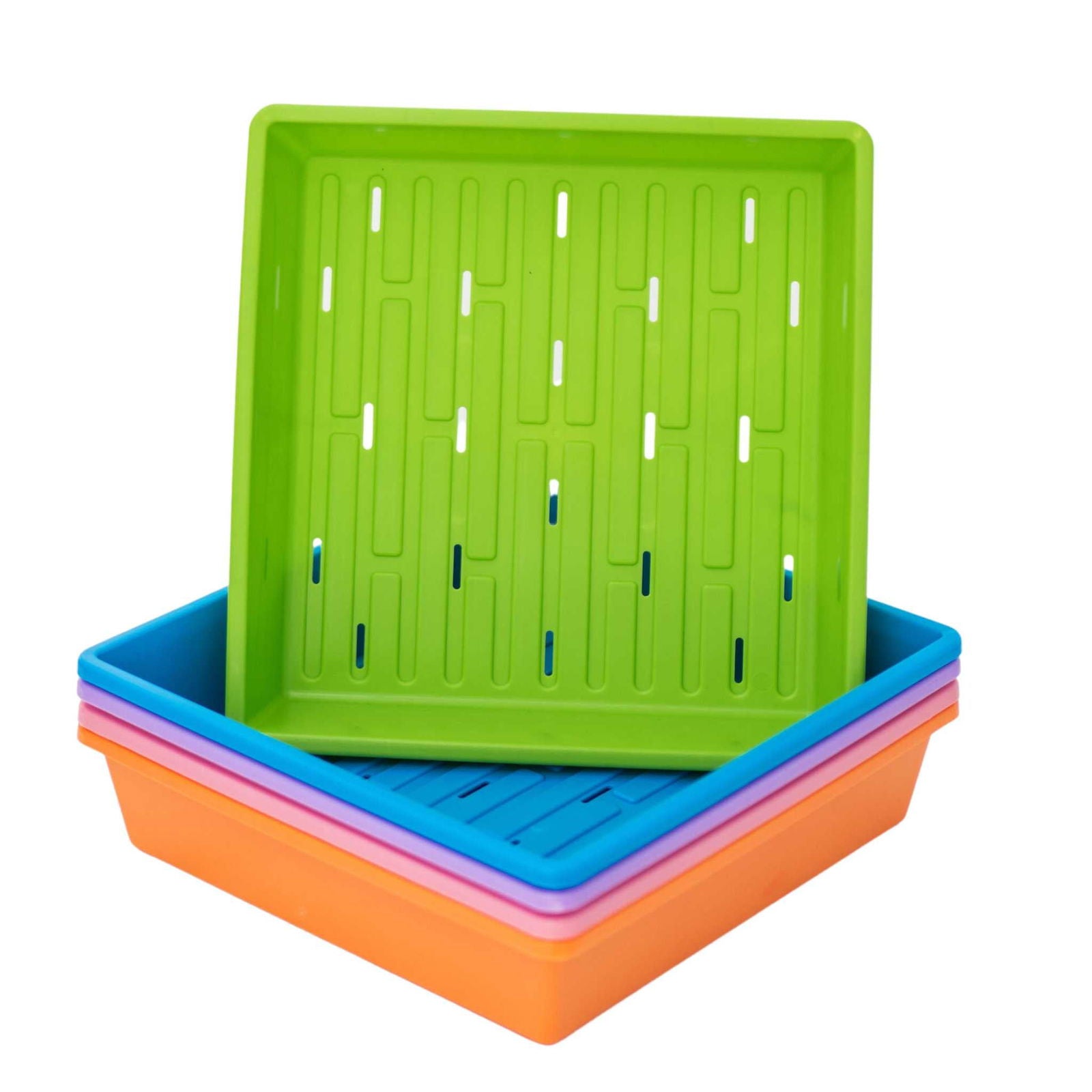 Plastic seedling trays in bright green blue pink and orange showing drainage holes and a grid pattern.
