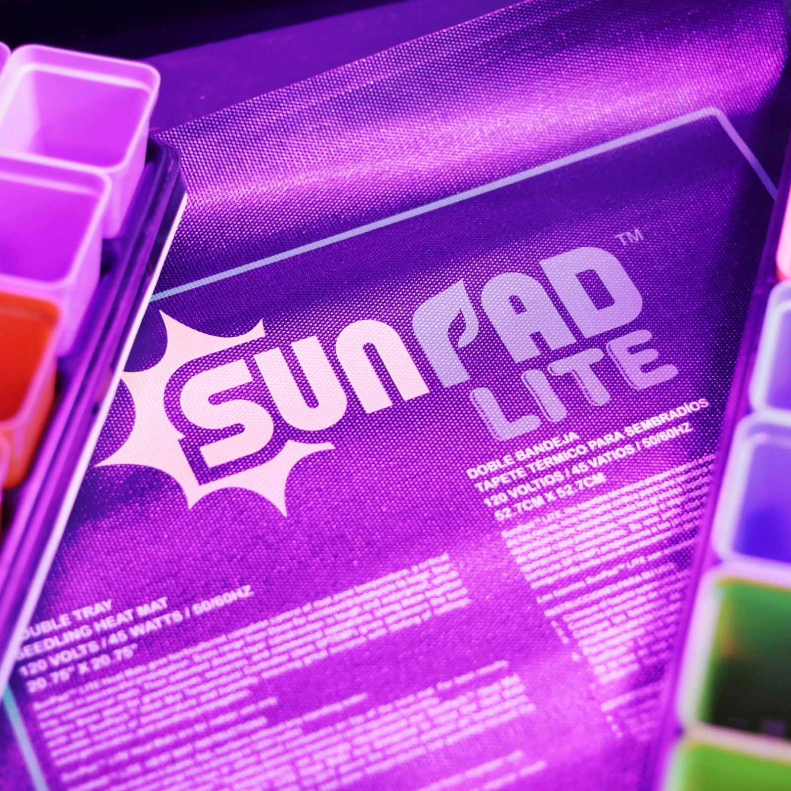 Product shot of a purple SunPad Lite seedling heat mat with accompanying seedling trays showcasing the brand logo vibrant color and detailed product information.

