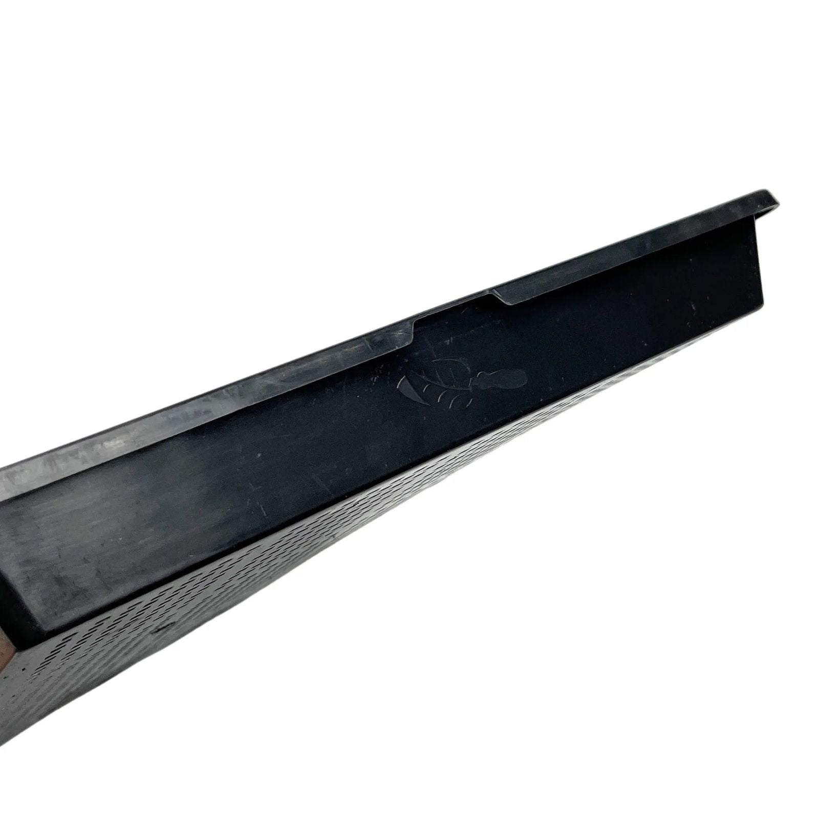 Plastic tray showing a textured bottom a raised edge and a logo.