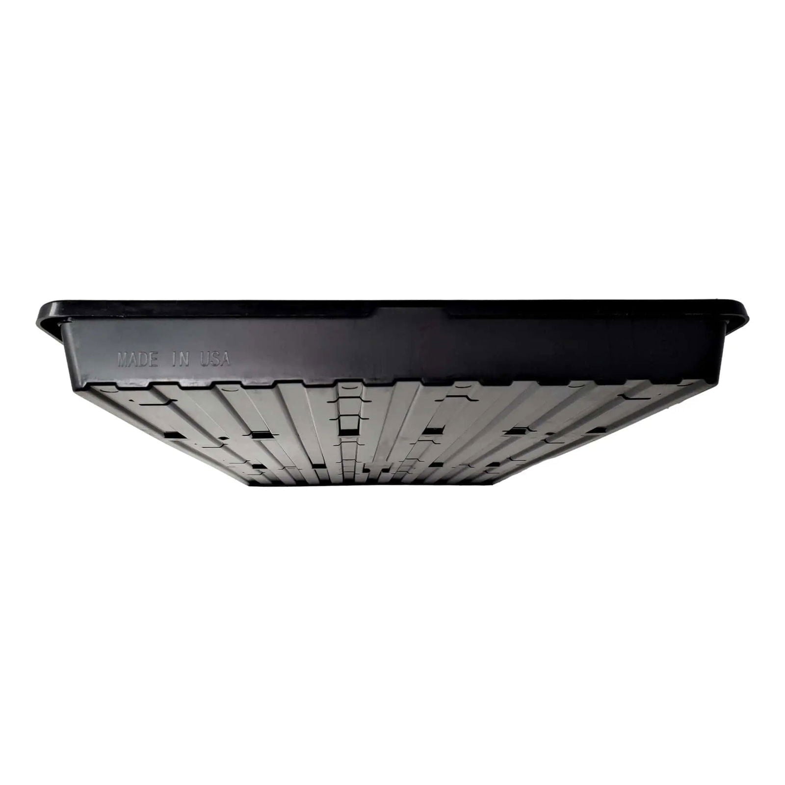 Plastic tray made in the USA shows a ribbed bottom with small drainage holes and a dark gray Made in USA imprint on the black rim
